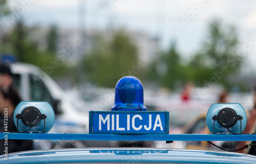 Bilde på lerret Polish Milicja (Old Police) sign on a old car