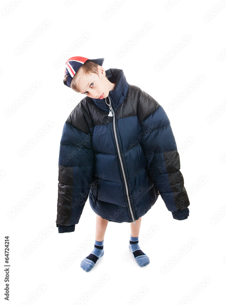 Cute funny child wearing a big winter jacket and cap Stock Photo | Adobe  Stock