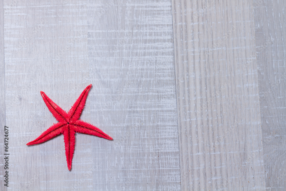 Close-up of red starfish on old wooden deck Close-up of red starfish on old wooden deck