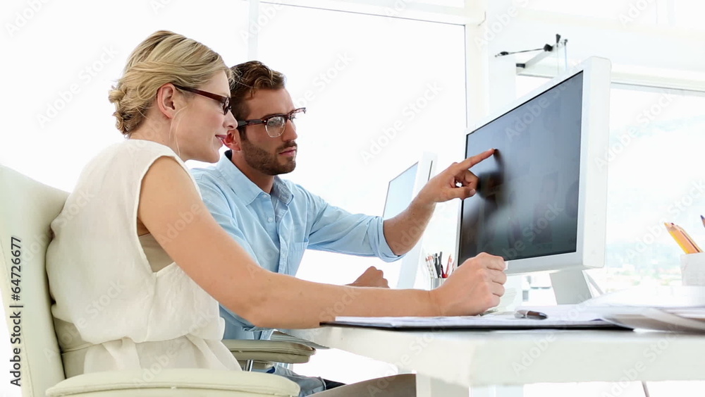 Focused creative team working together at desk Focused creative team working together at desk