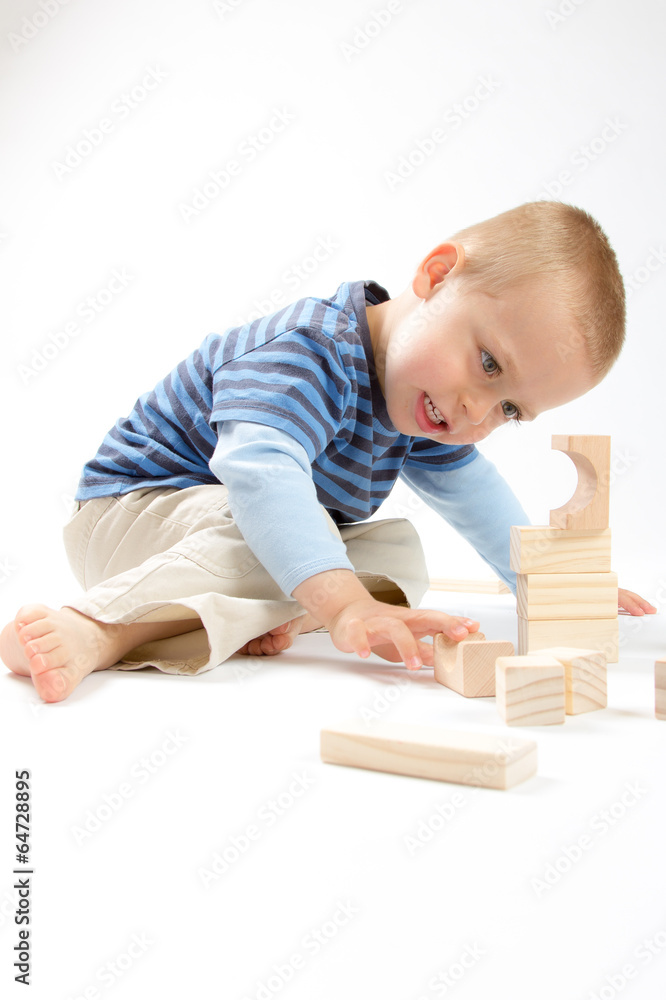 Little cute boy playing with building blocks. Isolated on white. Little cute boy playing with building blocks. Isolated on white.