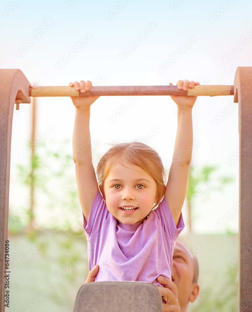 Fototapeta premium Happy child lifting on crossbar