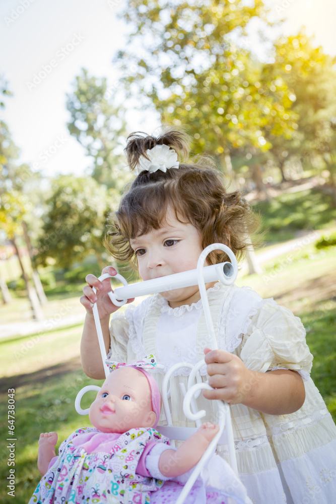 Adorable Young Baby Girl Playing with Baby Doll and Carriage Adorable Young Baby Girl Playing with Baby Doll and Carriage