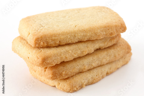 Butter biscuits in a stack on a white surface.