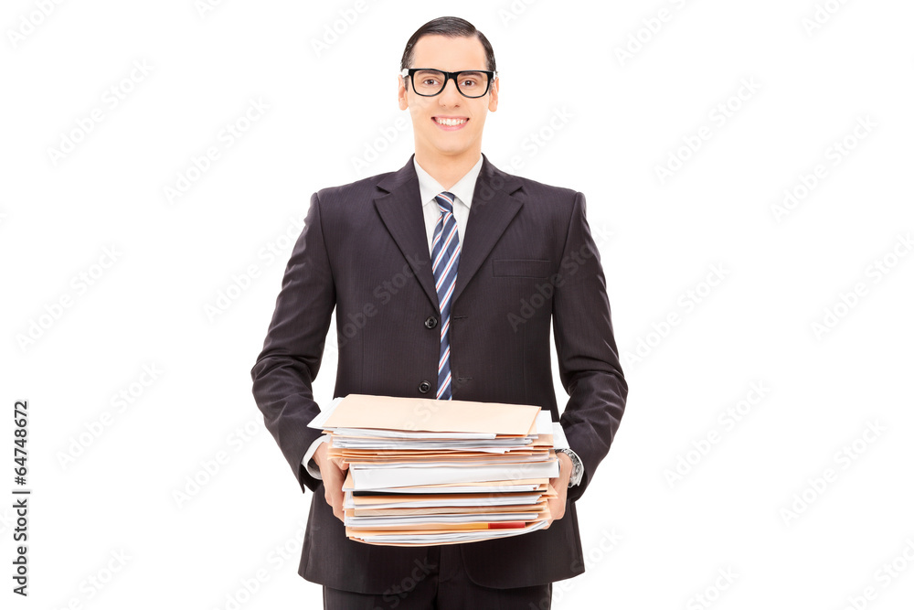 Happy businessman holding a pile of paperwork Happy businessman holding a pile of paperwork