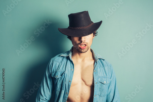 Sexy young cowboy with open shirt © LoloStock