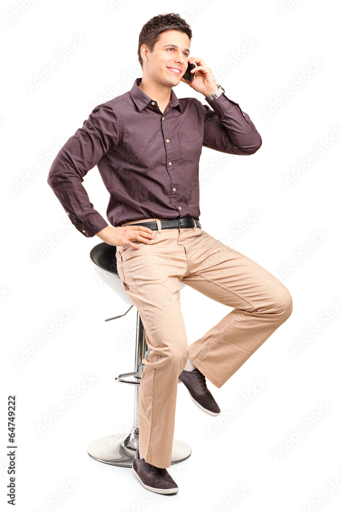 Young man in trendy clothes talking on the phone Young man in trendy clothes talking on the phone