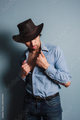 Sexy young cowboy with his shirt open