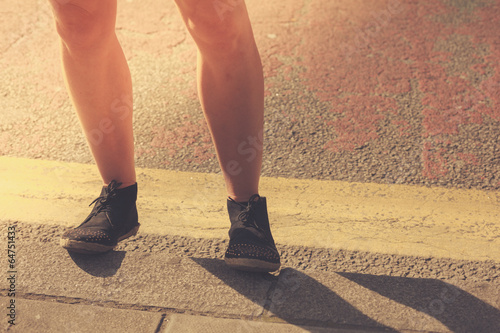 Closeup on a young woman's legs in the street