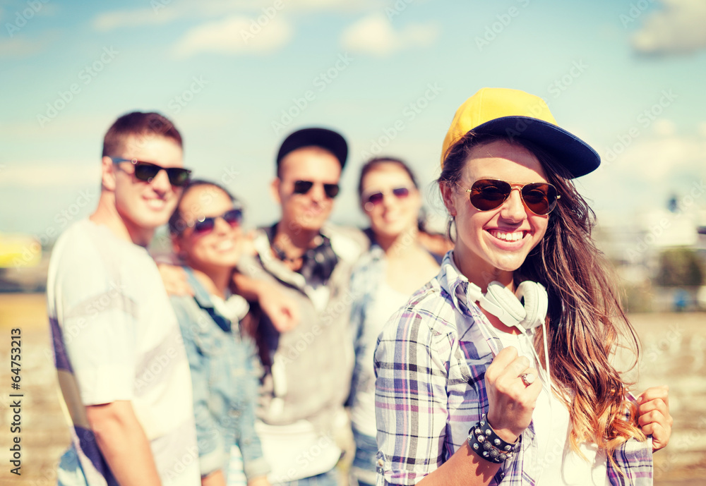 teenage girl with headphones and friends outside teenage girl with headphones and friends outside