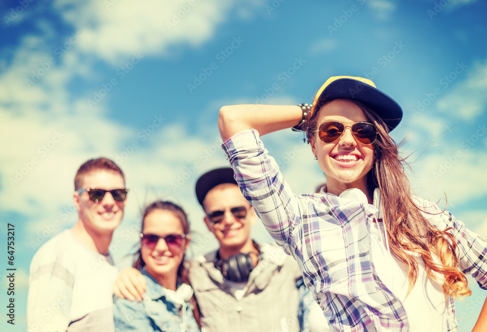 teenage girl with headphones and friends outside teenage girl with headphones and friends outside