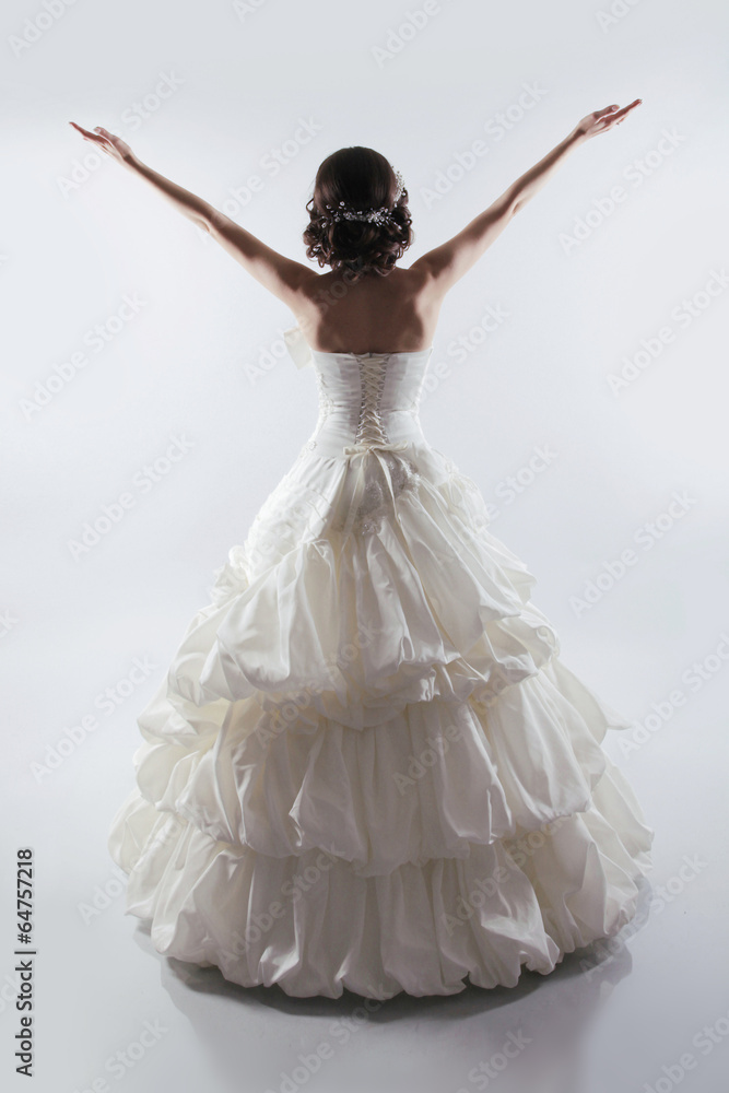 Naklejka premium Beautiful Bride open arms wearing in gorgeous wedding dress. Fas