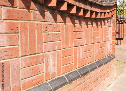 A square patterned brickwall built with good quality red bricks