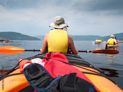 Tourists kayaking in river, Quebec, Canada photo