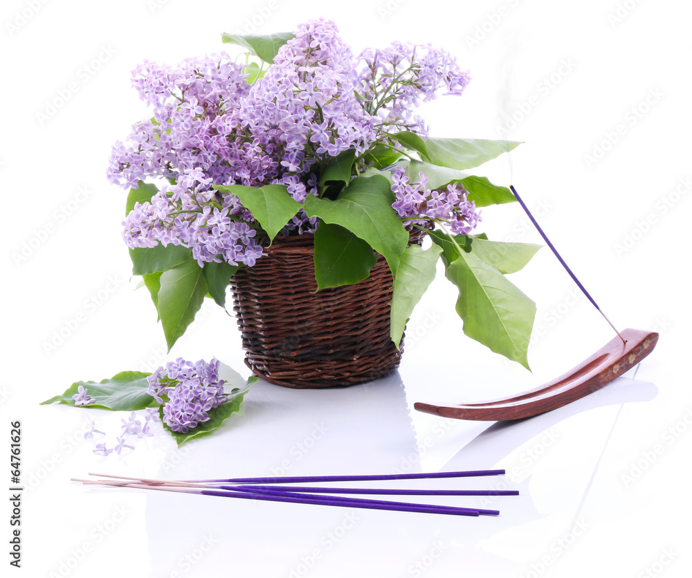 Fototapeta premium Lilac bouquet in a wicker basket and incense set