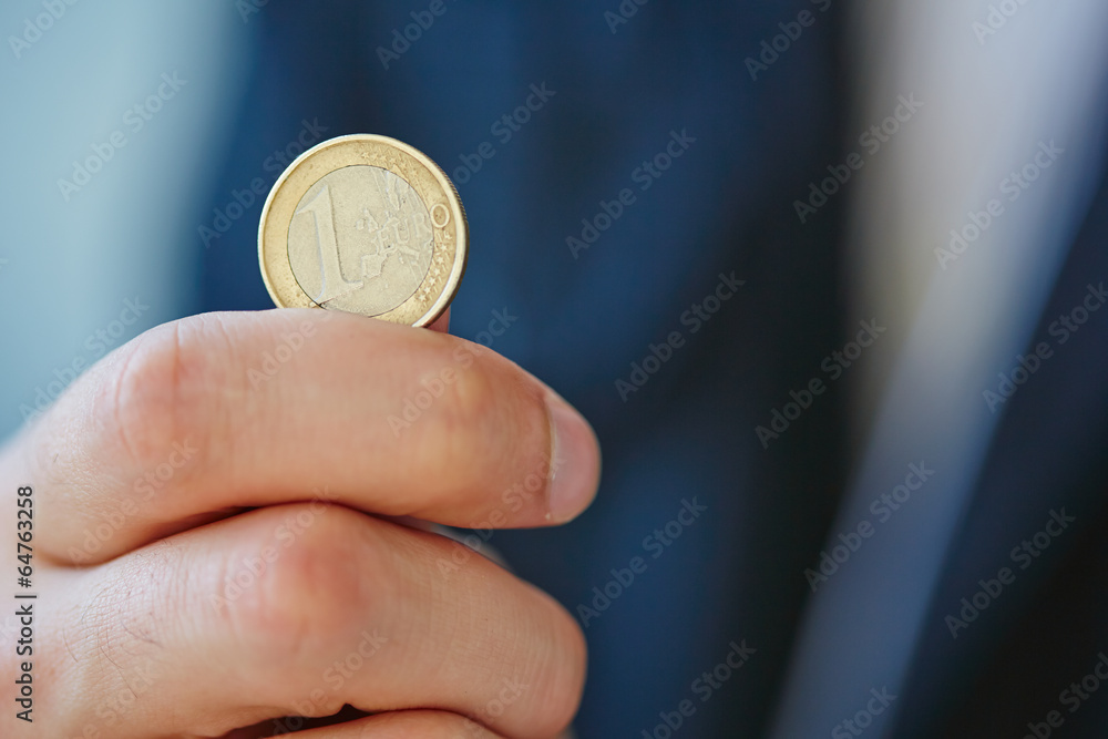 Fototapeta premium hand with euro coin