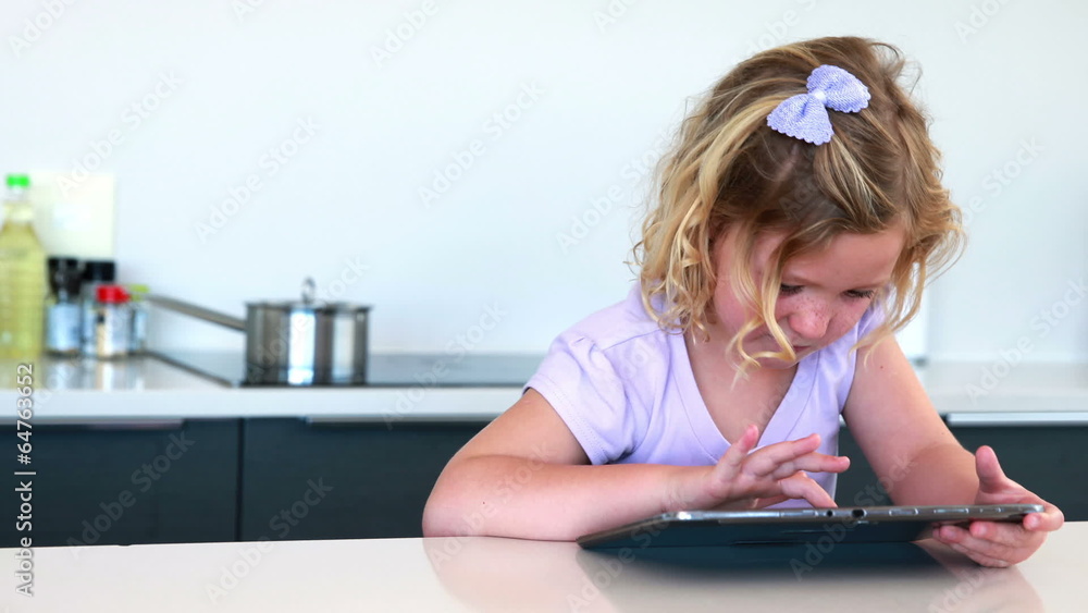 Little girl using a digital tablet Little girl using a digital tablet