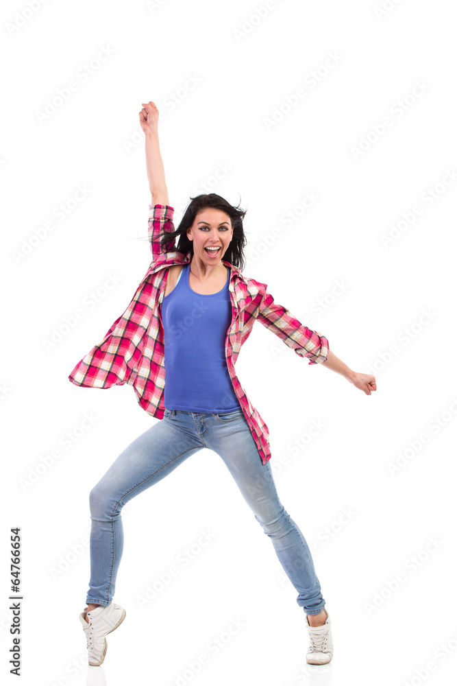 An attractive woman shouting and punching the air. An attractive woman shouting and punching the air.