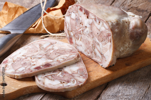 Headcheese chopped slices on kitchen board