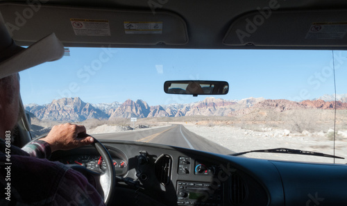 Man driving a car on road, Death Valley National Park, Californi photo