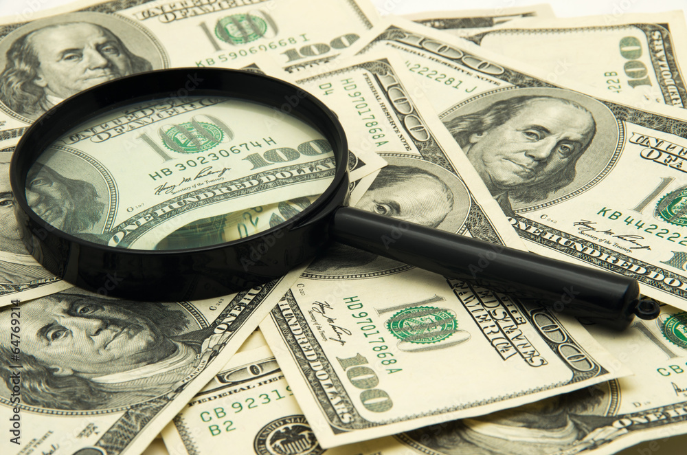 Magnifying glass and money - business background Magnifying glass and money - business background