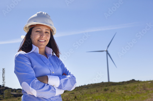 Beautiful engineer standing at wind farm