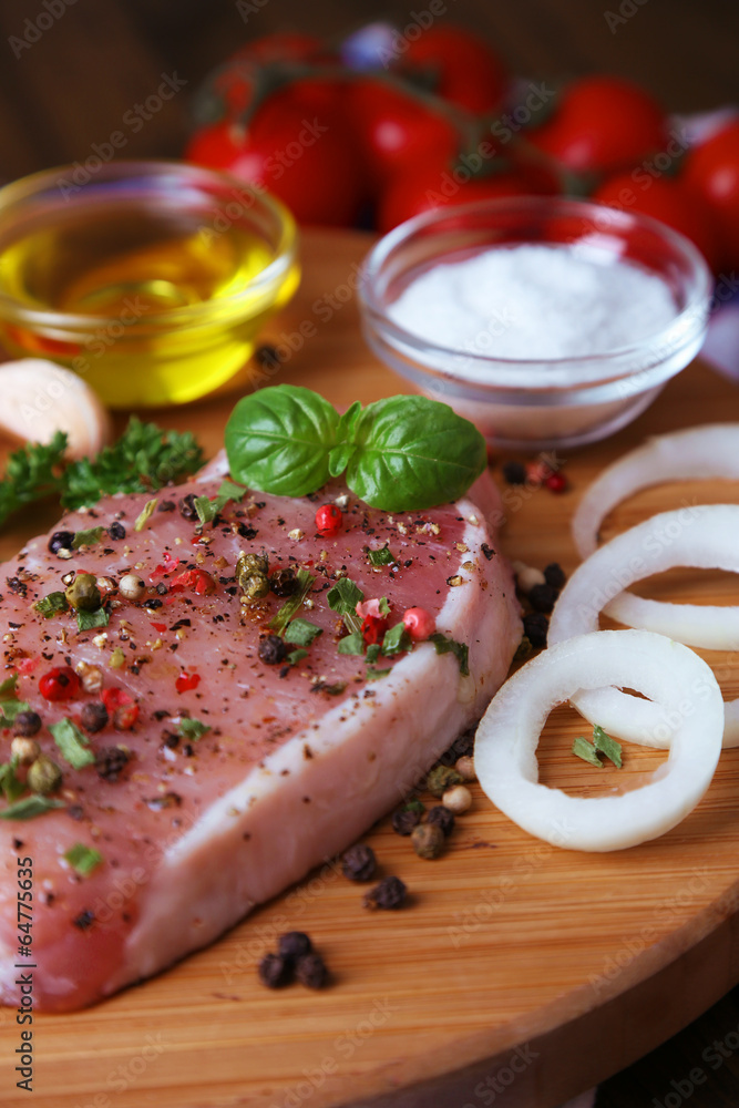 Raw meat steak with herbs and spices