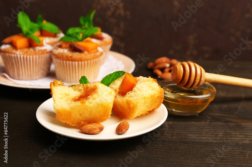Tasty pumpkin muffins on wooden table