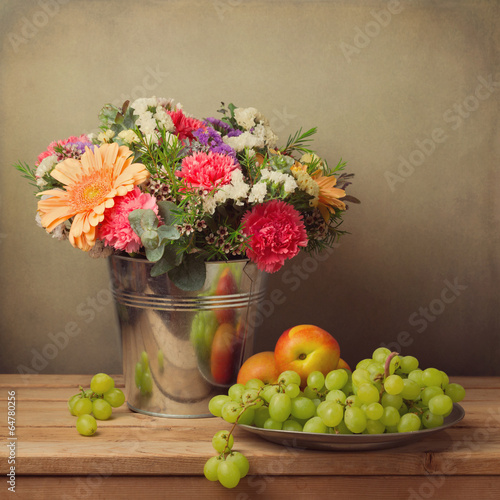 Wallpaper Mural Flower bouquet in bucket and fresh fruits on wooden table Torontodigital.ca