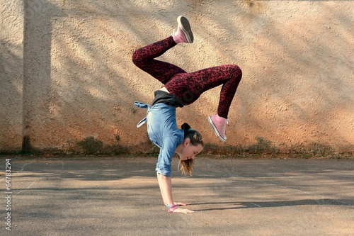 Young girl dancing breakdance on the street