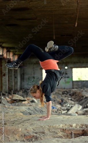 Teenager dancing breakdance in the old brickworks