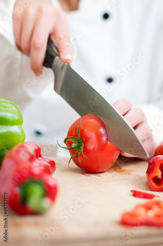 chef cutting tomatoes
