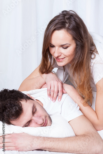 Wife watching husband sleep