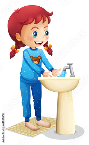 A cute little girl washing her face