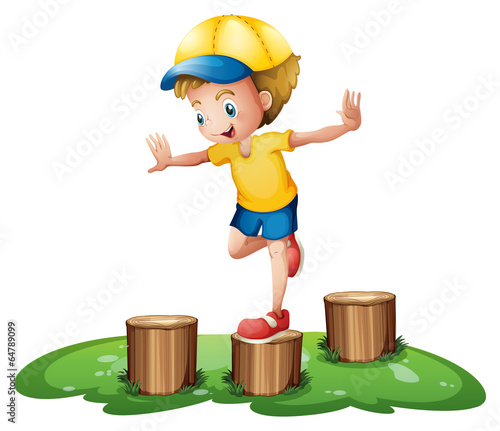 A smiling boy playing with the stumps