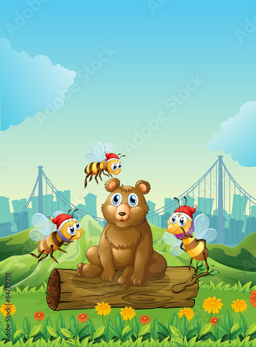 A big bear above the log with three bees
