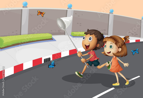 Kids catching butterflies at the street