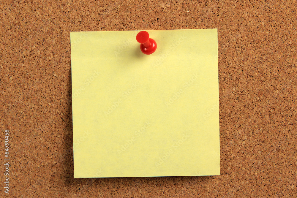 yellow sticky note on a cork board yellow sticky note on a cork board