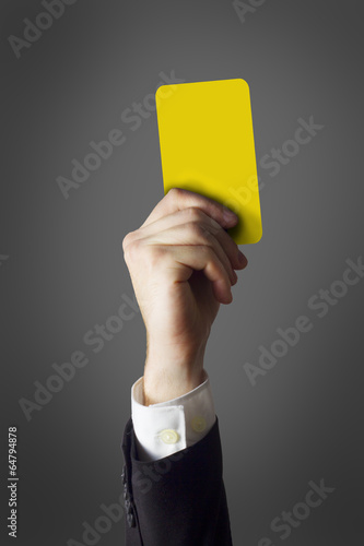 businessman showing yellow card