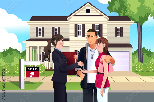 Real estate agent in front of a sold house with her customer