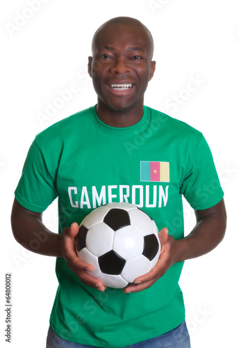 Laughing soccer fan from Cameroon with ball