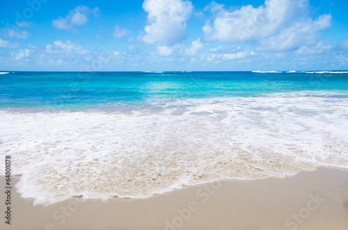 Wave on the sandy beach photo