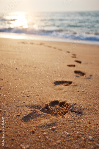 Footprints on the beach sand.Traces on the beach. Footsteps on t © ZoomTeam