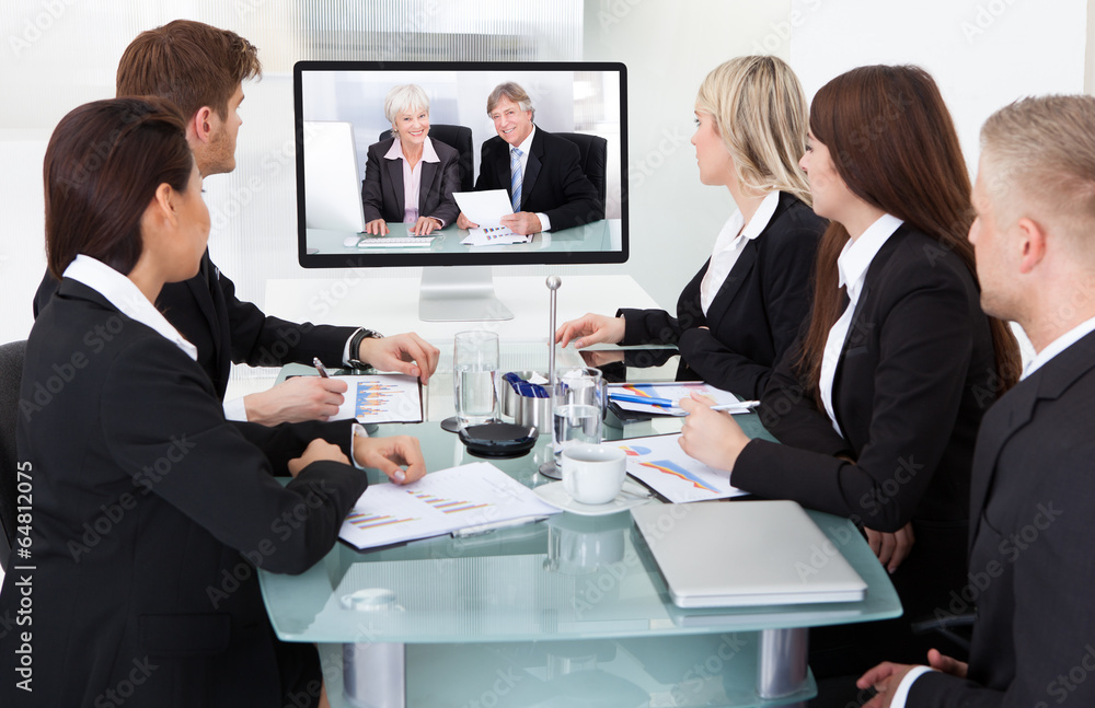 Businesspeople Attending Video Conference Businesspeople Attending Video Conference