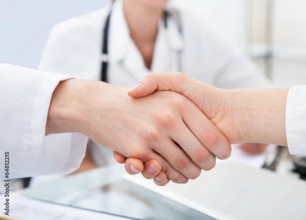 Doctors Shaking Hands At Desk Doctors Shaking Hands At Desk