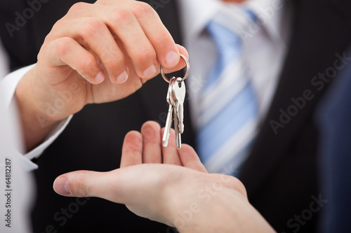 Estate Agent Giving House Keys To Man