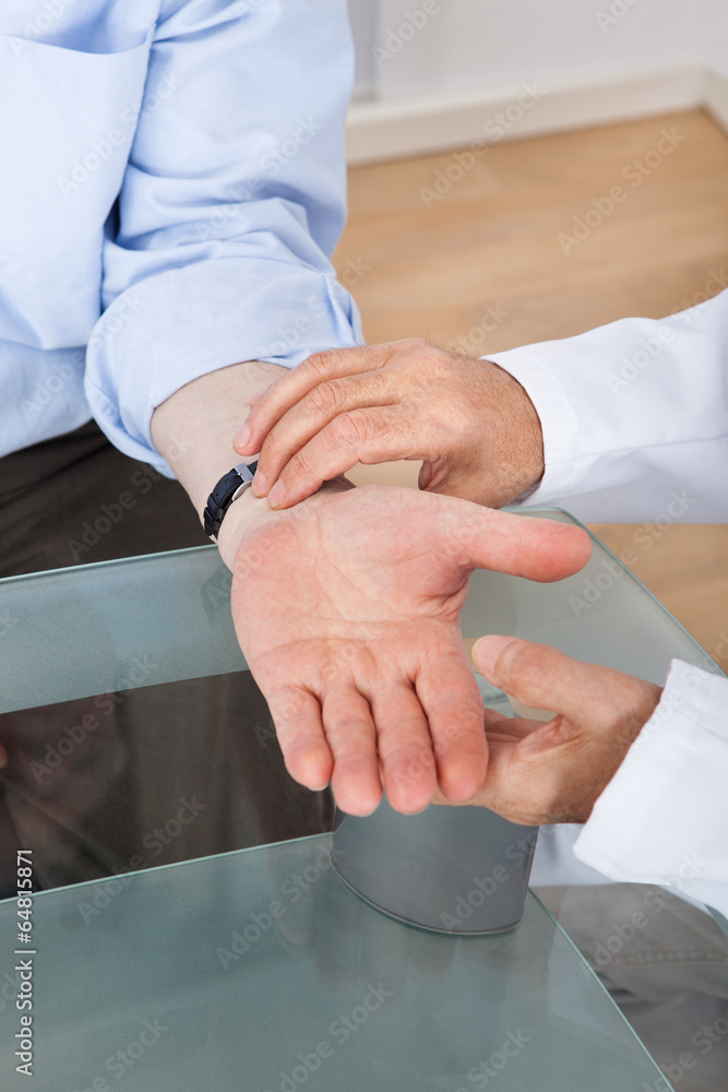 Doctor Taking Senior Man's Pulse