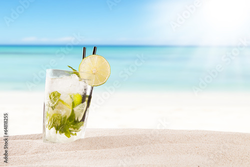 Summer mojito drink with blur beach on background