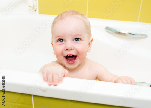 baby boy taking bath and pl...