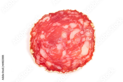 Slice of salami sausage on a white background